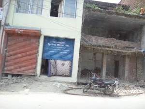 The building on the right was destroyed by the quake. The surviving building is on the left.